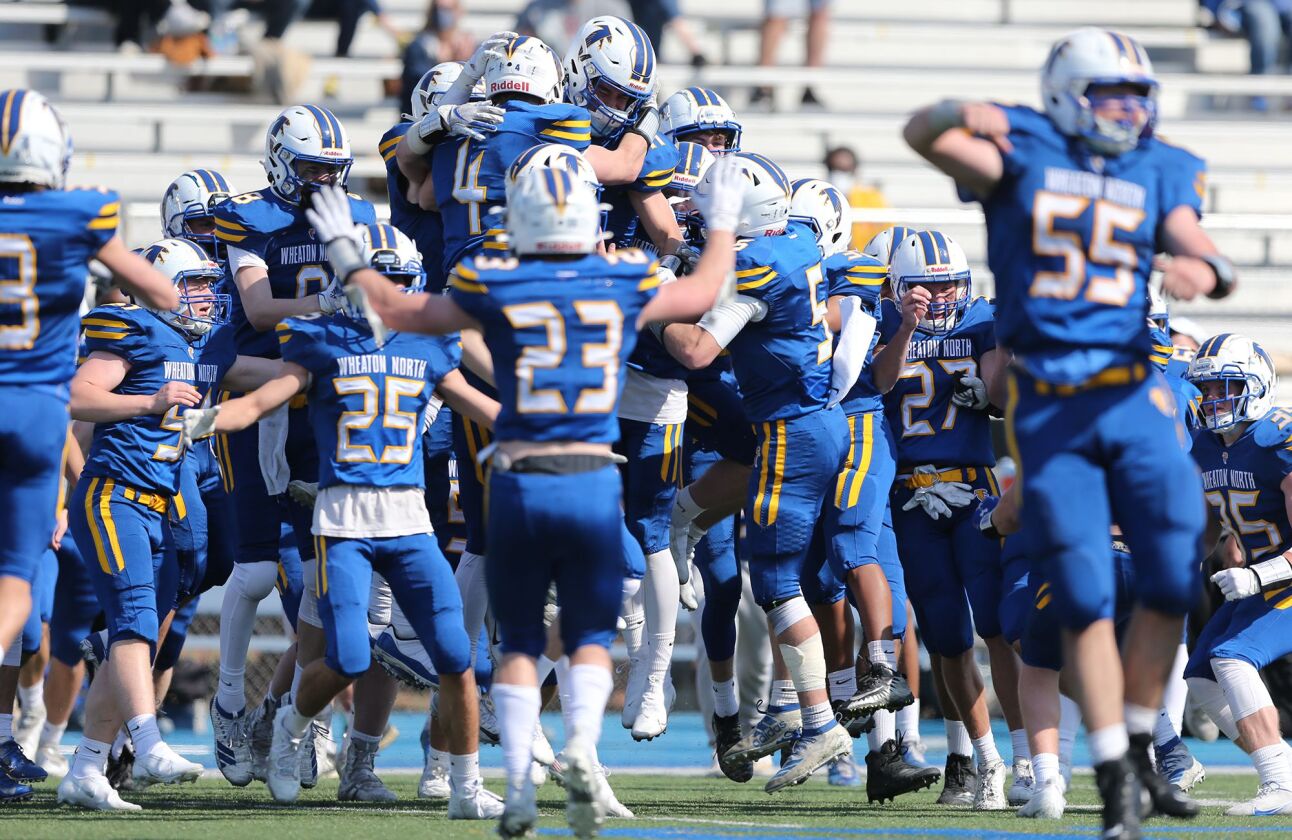 Wheaton North players celebrate their 17-14 victory over Wheaton Warrenville South.